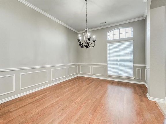 Formal dining room with wood floors.