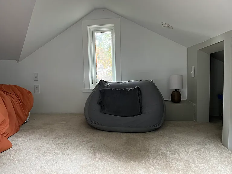Sleeping loft w/ two windows, skylight, & ceiling lights.