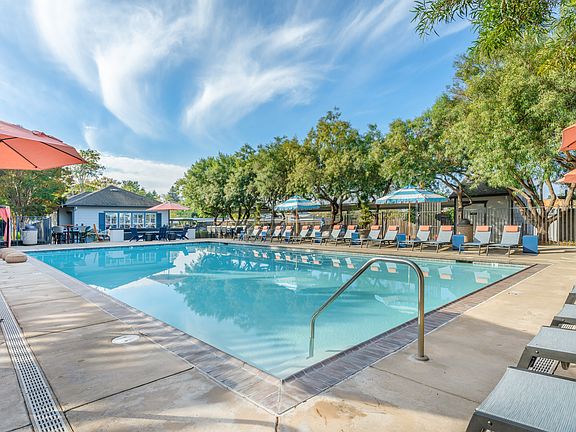 Our resort style swimming pool is filled with lounge chairs and umbrellas