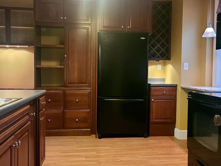 Kitchen view from back porch entry; 
stove/microwave to the right with sink/dishwasher to the left.