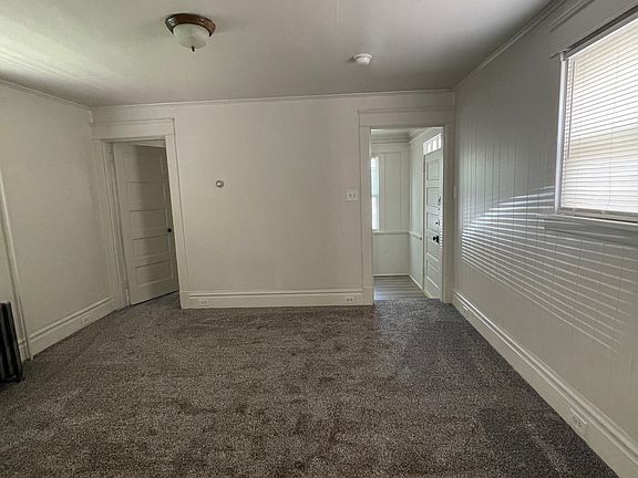 Spacious living room new carpet and padding.