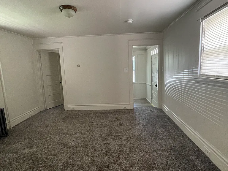 Spacious living room new carpet and padding.
