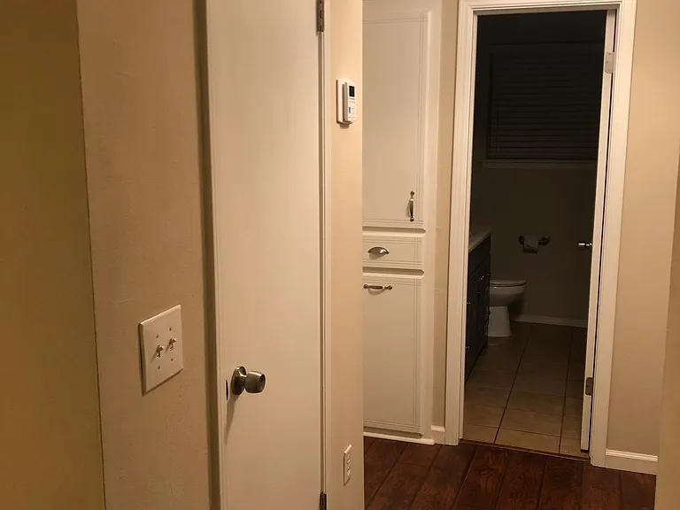 Standing in living room looking to the hall closet & then the main bathroom