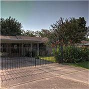Another front view of the home with the iron fence completely closed.