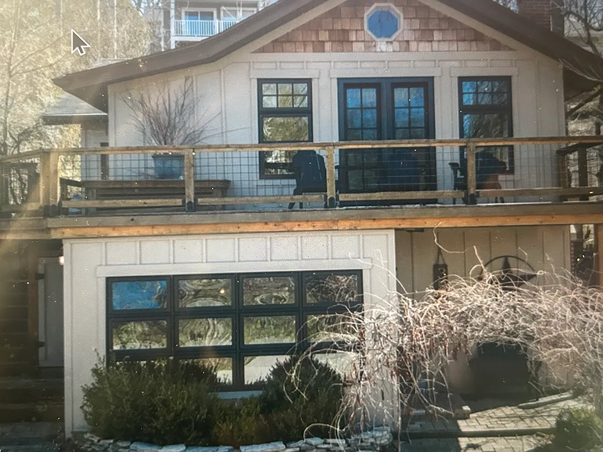Front deck with Adirondack chairs and French Doors into open floor plan main room and kitchen - 3560 Reeds Lake Blvd SE