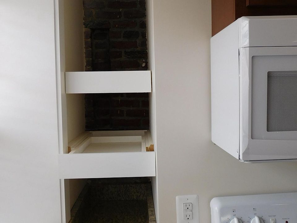Pull out kitchen storage shelves in front of exposed 1859 br