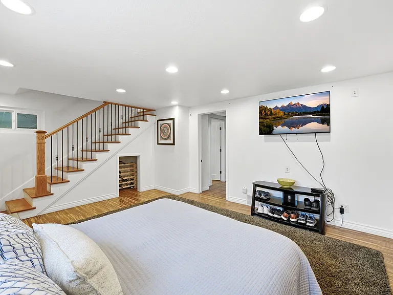 Main room on the lower level. Can be used as additional family room with adjacent bedroom and bathroom or as a master suite and office as pictured.