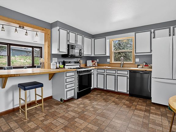spacious open kitchen with solid maple breakfast bar, extra large refrigerator, and gas stove.