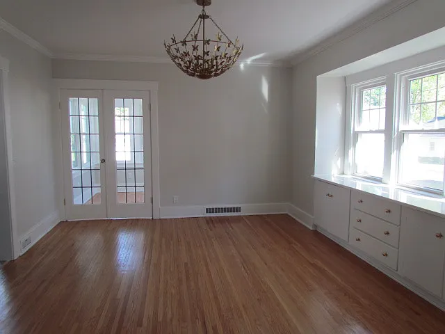 Full Dining Room shot. Note the Contemporary flaired chandelier , and wall of southern-facing windows!