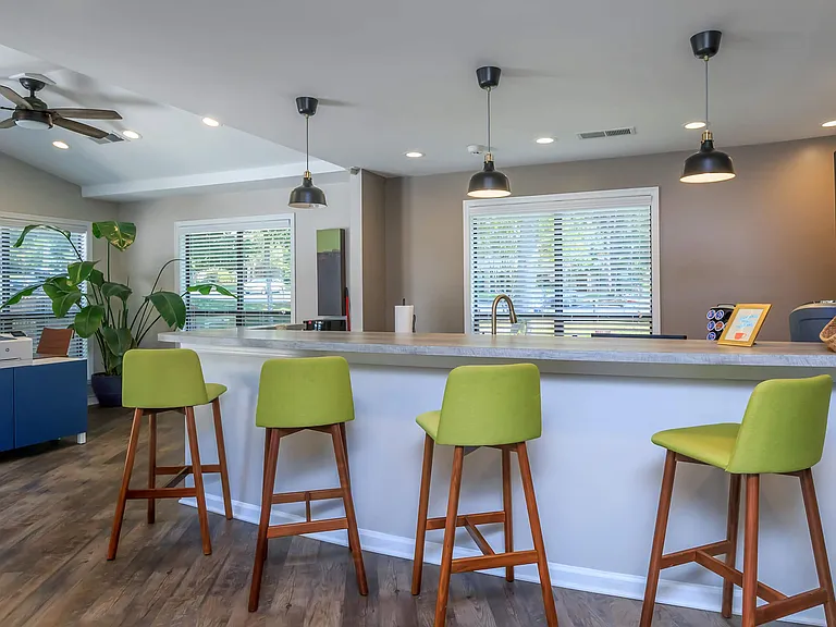 Kitchen with Modern Countertops and Vibrant Bar Stools - Leasing Office
