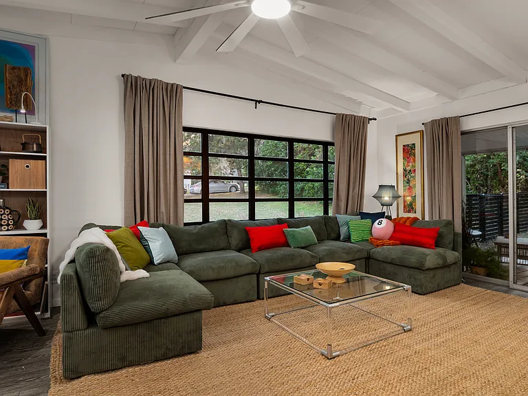 Large front window looks out onto expansive front lawn and quiet street. Big comfy couch and large wall mounted 65" TV perfect for movie night. Patio doors lead to outdoor dining area with dual propane/charcoal grill.