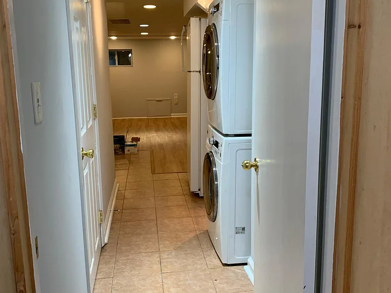 Washer dryer is across from bathroom