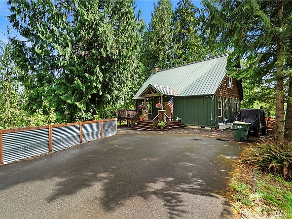 Paved driveway provides lots of parking and the metal roof blends into the landscape perfectly.