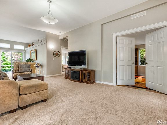 Living room with view of the den with double doors. 