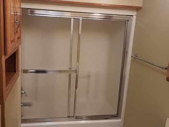 Bathroom is well-lit with new vanity mirror and lighting