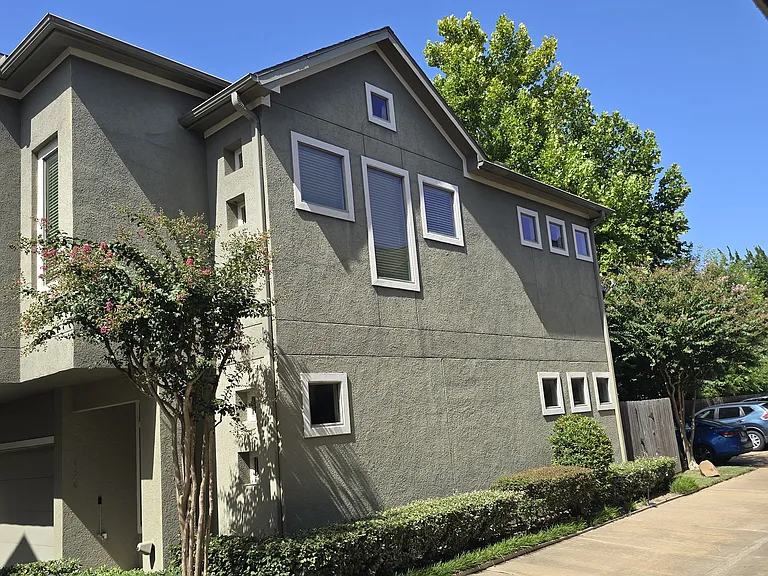 Side view of house with additional guest parking in view.