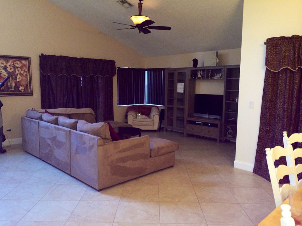 Large living room with vaulted ceilings and bay windows, bra
