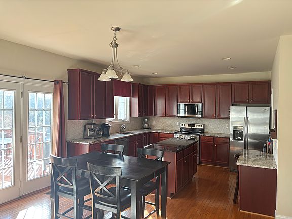 Large kitchen with eat in dining and southern exposure opens into living room and deck