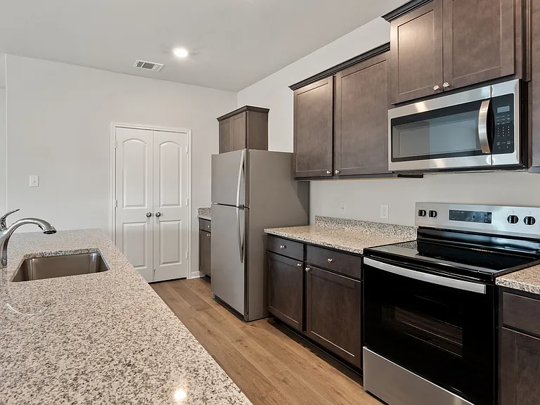 The kitchen has sprawling granite countertops.