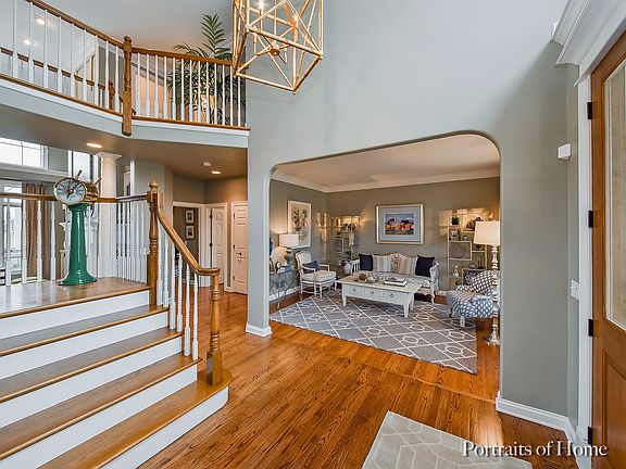 Dramatic 2 story Foyer w/gorgeous hardwood floors, fresh paint, new lighting, wide staircase & lovely archways frame the Living & Dining rms.