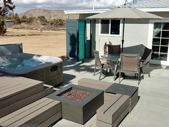 Patio with hot tub, shower and fire pit
