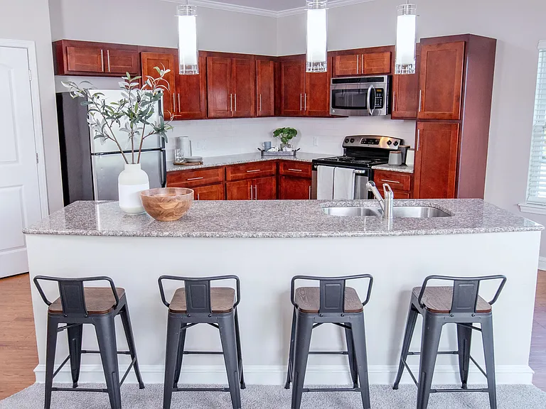 Experience culinary delight in your open kitchen, featuring a spacious breakfast bar and contemporary pendant lighting for an elevated dining experience.