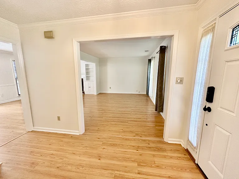 Another view from the foyer into the den and living room.