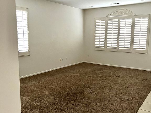 View of living room with beautiful shutters.