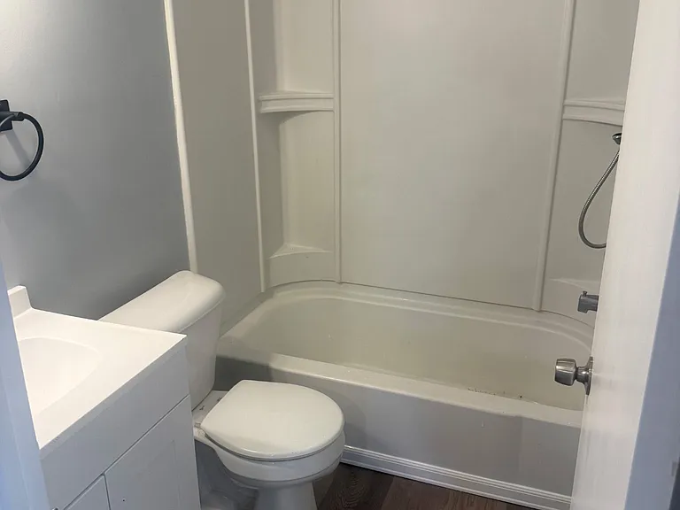 Upstairs newly renovated master bathroom with new vanity, mirror, lights, and appliances