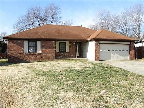 Front view of home; a brick and permanent sided exterior