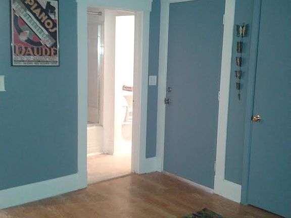 Inside view of entrance door (closed) and bathroom door (open)