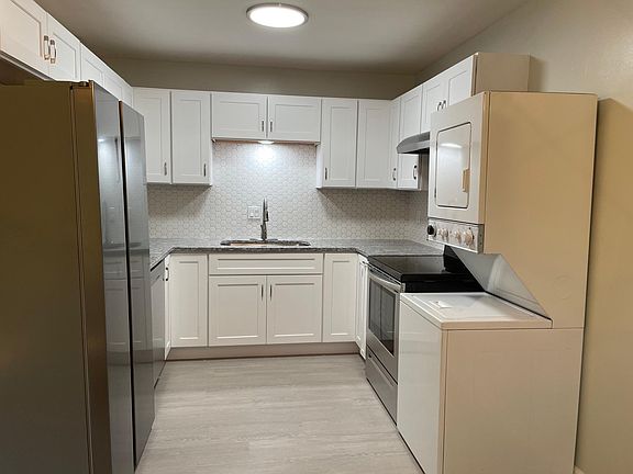 Fully equipped kitchen, new cabinets, granite counter tops, fridge, and modern LED lighting.