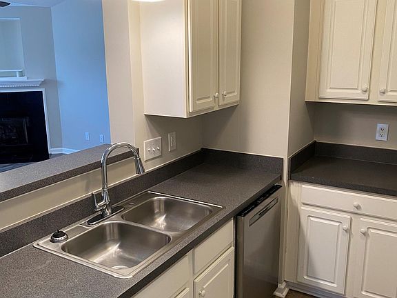 Kitchen with tons of cabinet storage and countertop work space. New lighting and faucet.