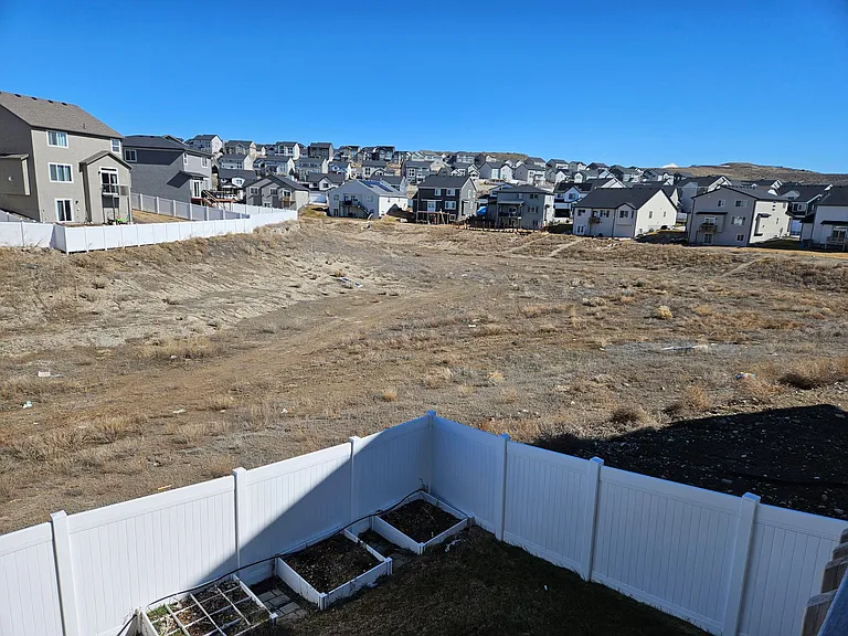 Open space is currently being finished by the city with a small park and walking paths. Fenced backyard has back gate for easy access onto the miles of trails of Eagle Mountain!