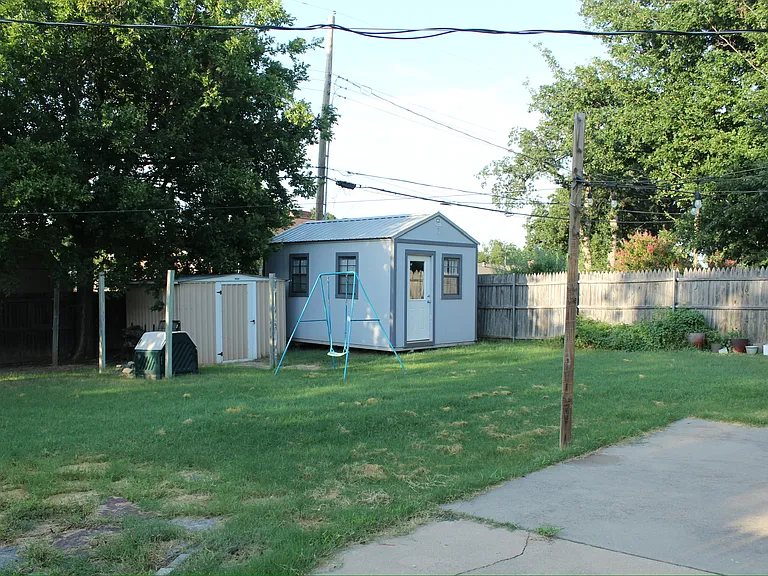 Backyard view from patio. 
**Please note: the blue/gray storage building is not accessible to the tenants. The owner will occasionally need to access with notice to the tenant.
