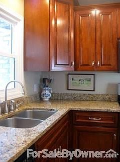 Kitchen with granite counters
						:
						View from sink to fenced-in backyard, ideal for family with young kids
