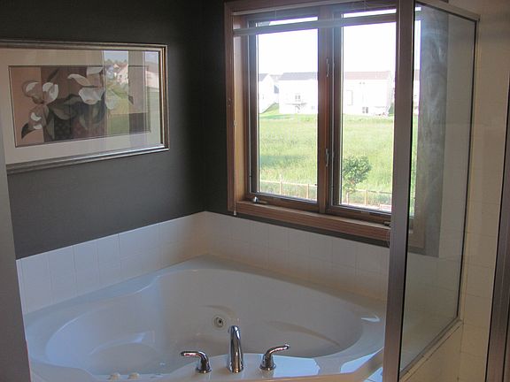 Master bath has corner whirlpool tub and separate shower
