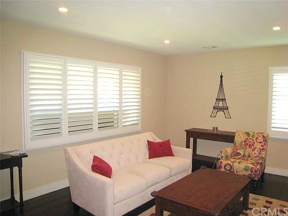 Spacious Living Room. Notice the recessed lighting, custom shutters and 5" baseboards