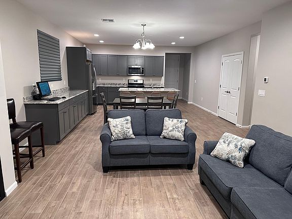 great room with kitchen island, double door pantry and extended counter