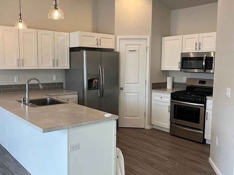 Kitchen with dishwasher, garbage disposal, gas range, fridge and pantry