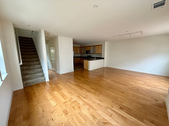 Large living room area with hardwood floors