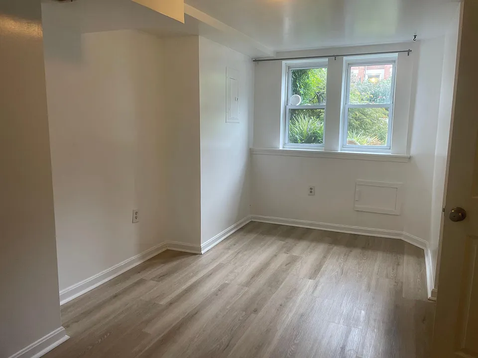 Front bedroom. This is the larger of the two bedrooms. A full/queen sized bed fits comfortably under the windows or along the wall to the left.