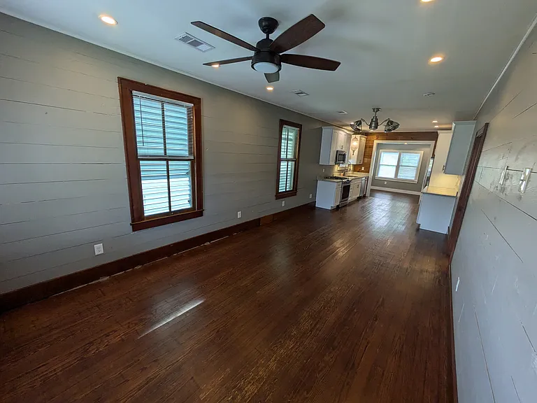 Large living room / dining room area looking from front door. Recessed lighting with dimmers and three-way switches throughout.