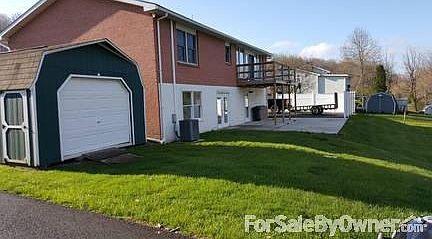 REAR OF HOUSE
						:
						VIEW FROM REAR SHOWING, 14 X 28 GARAGE/SHED, PATIO, FRENCH DOORS, AND DECK