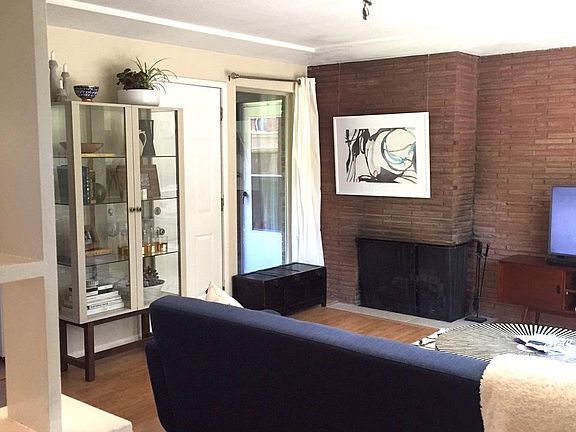 living room with MCM brick & working fireplace
