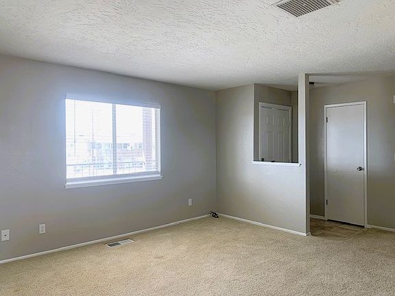 Spacious living area with small coat closet.
