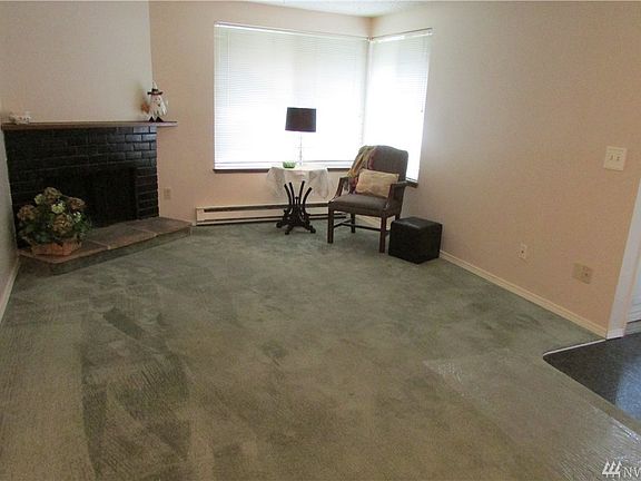 Living room with wood burning fireplace - fresh paint and carpets cleaned.