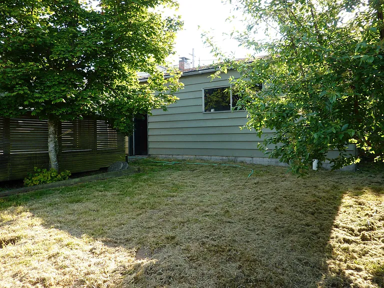 Fenced back yard. Building shown is garage, 430' square.