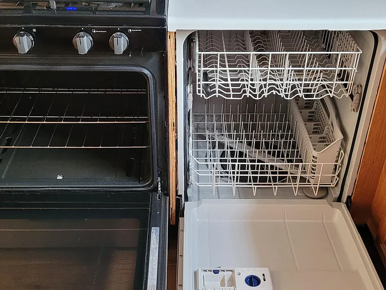 Side-by-side stainless stove and dishwasher.
