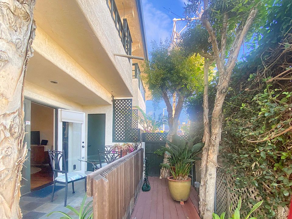 Ground floor unit enjoys full decking and patio with gorgeous mature landscaping and plenty of SoCal sun!